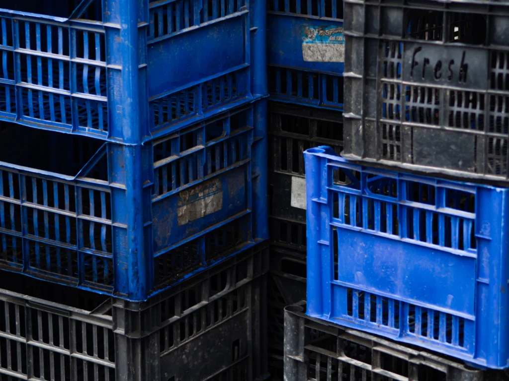 Stacks of blue dairy crates ready for delivery