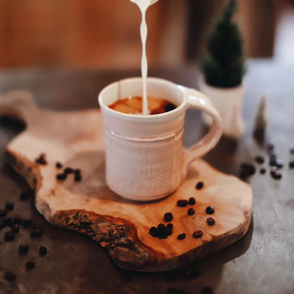 A cup of milky tea on a wooden board