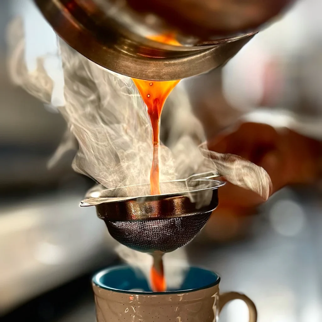 Hot chai being poured into a cup